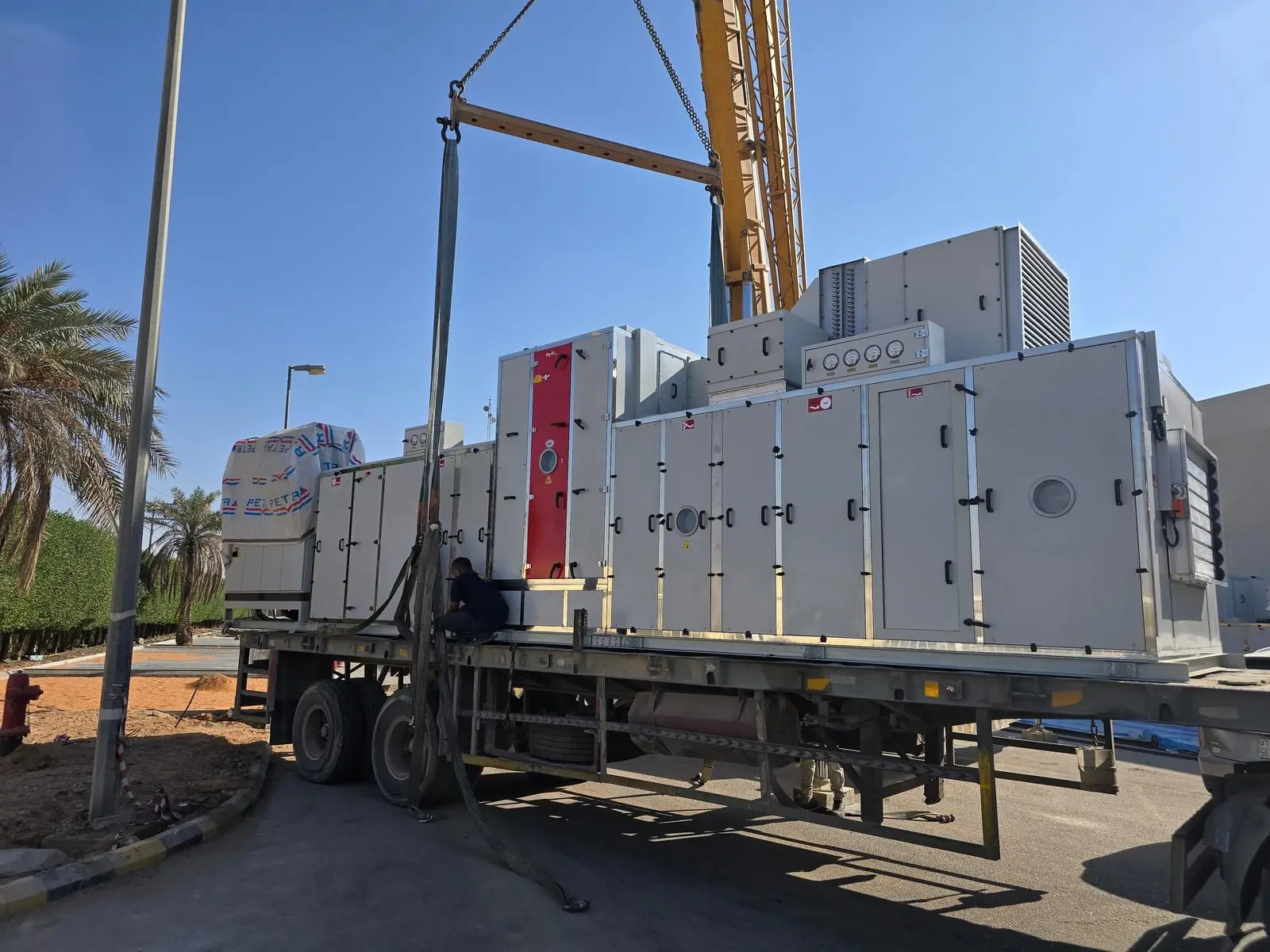 Air-handling equipment being lifted from a trailer