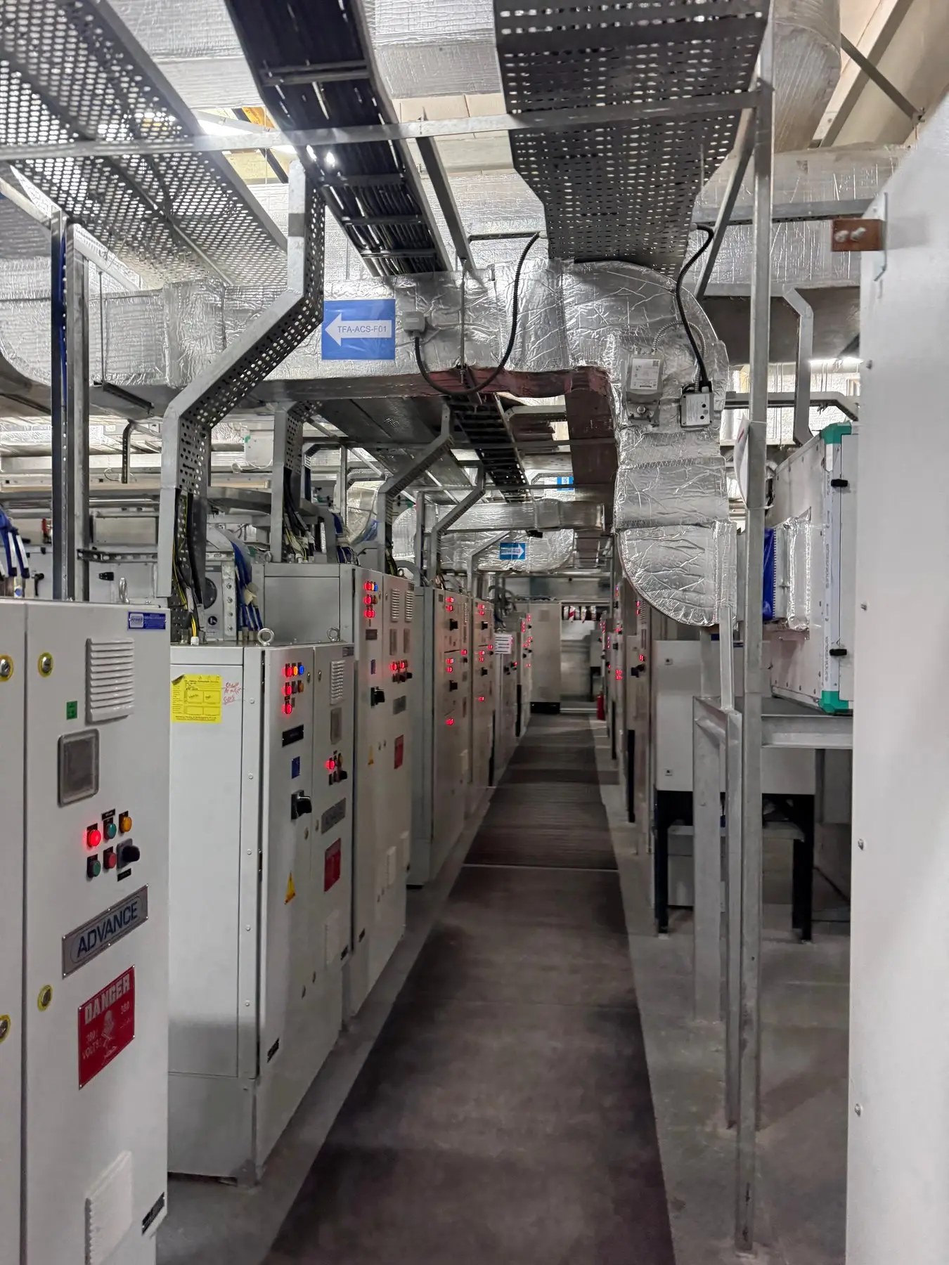 Installed electrical panels along a service corridor